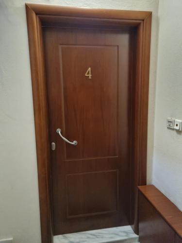 a wooden door with the number four on it at cozy panta in Orestiada