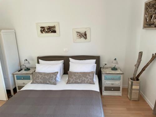 a bedroom with a large bed with two night stands at Apartments CLIFF Piran in Piran