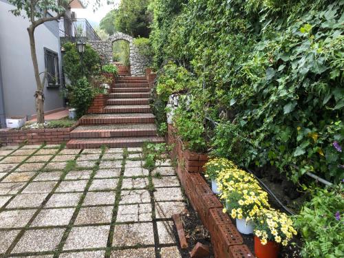 a set of stairs in a garden with flowers at Villa Roccia Scura dell'Etna in Zafferana Etnea
