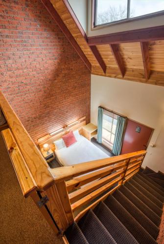 a room with a bed in a brick wall at AAt 28 Goldsmith Motel in Hamilton