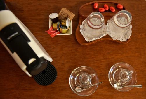 a hair dryer and glasses on a wooden table at Hotel Sophia in Hydra