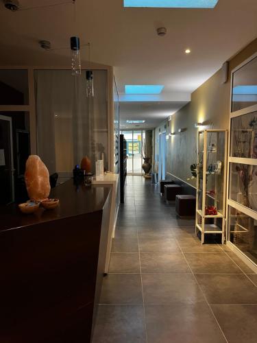 a kitchen with a counter and a hallway with a room at Hotel Oasi Wellness & Spa in Riva del Garda