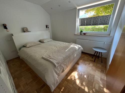 a small bedroom with a bed and a window at Pod Galetovcem in Bohinjska Bela