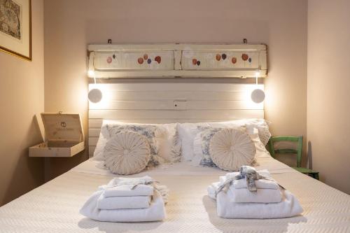 a bedroom with a bed with two towels on it at La Pulcia B&B in Gradara