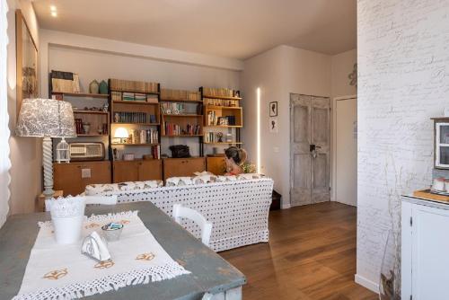 a woman sitting at a table in a room at La Pulcia B&B in Gradara