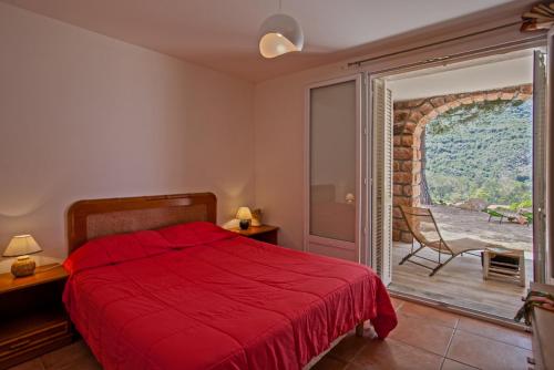 a bedroom with a red bed and a sliding glass door at Villa Kalliste in Porto Ota