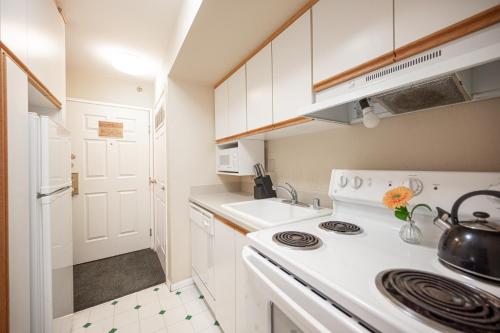 a white kitchen with a stove and a sink at Penthouse on the strip - 6 Comfy beds!!! in Las Vegas