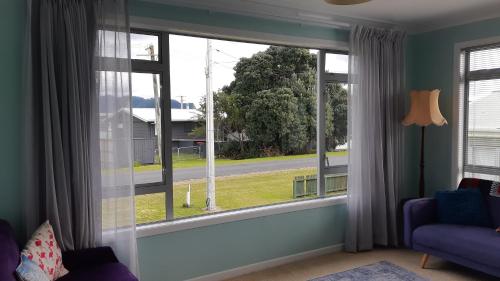 a living room with a window with a view of a street at Beach Belle in Bowentown