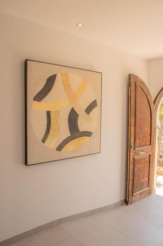 a painting on a wall next to a door at H Arena Mojacar in Mojácar