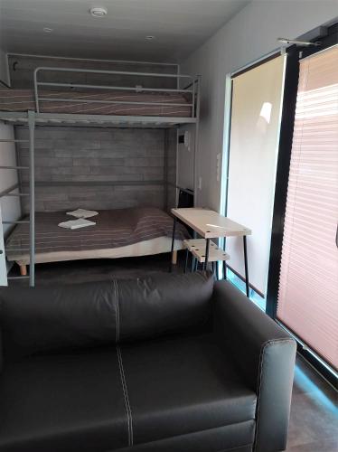 a living room with a bunk bed and a couch at Villa Marina in Augustów