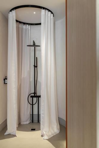 a door with a white curtain in a room at The Newel Psychiko in Athens