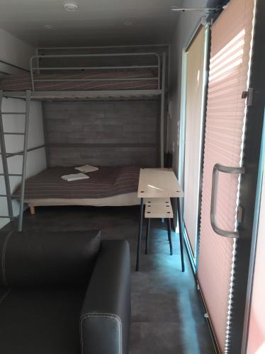 a bedroom with a bunk bed and a desk at Villa Marina in Augustów