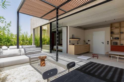 a living room with a white couch and some windows at The Newel Psychiko in Athens