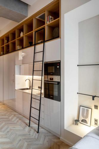 a kitchen with a ladder leaning against a wall at The Newel Psychiko in Athens