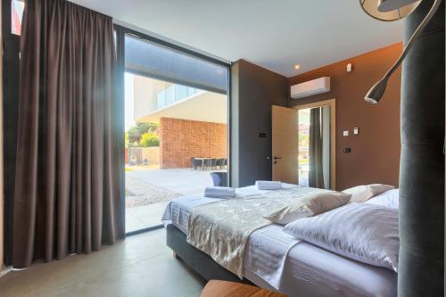 Postel nebo postele na pokoji v ubytování Villa Mediterraneo 2