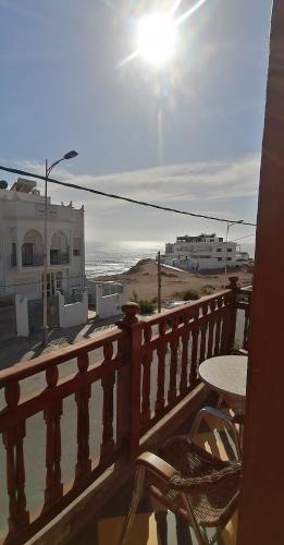 a balcony with a table and a view of the beach at TOODA House in Imsouane