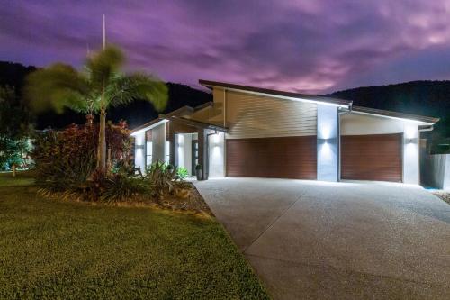 a house with a garage lit up at night at Airlie Beach Home in Airlie Beach