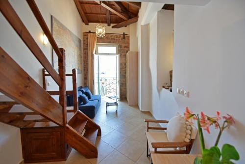 a living room with a blue couch and a staircase at Hotel Sophia in Hydra