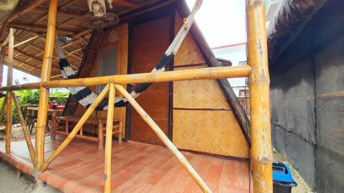an outside view of a house with a wooden floor at Calatagan's Bahay Kubo - with Beach Access in Batangas City