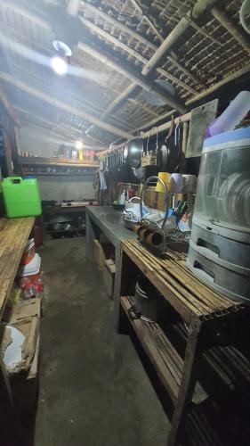 a kitchen with a table and a counter with pots and pans at Calatagan's Bahay Kubo - with Beach Access in Batangas City