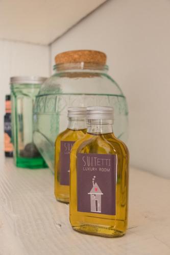 a bottle of oil sitting on top of a shelf at Sui Tetti Luxury Rooms in Lecce