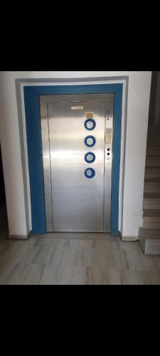 a elevator door with the number on it at Petit panta in Orestiada