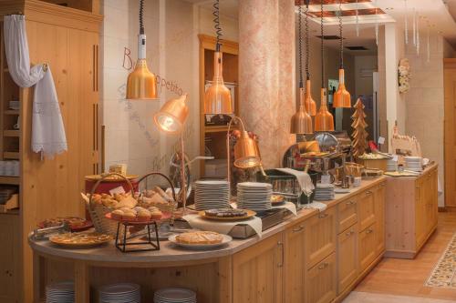 a kitchen with a table with food on it at Bellavista Relax Hotel in Levico Terme