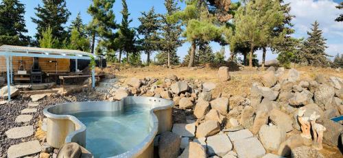 a pool of water in a pile of rocks at Ay La in El-Rom