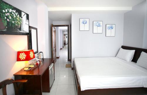 Krevet ili kreveti u jedinici u objektu Nhatrang Cozy Hotel
