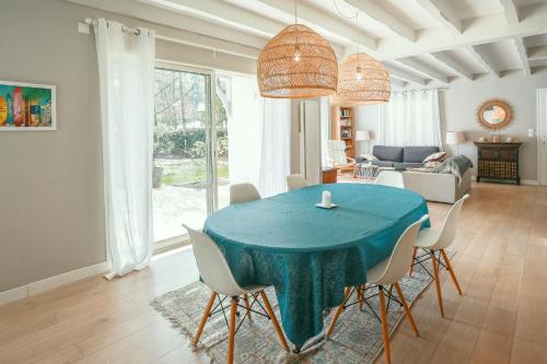 une salle à manger avec une table et des chaises bleues dans l'établissement Villa Pinkmary Pour 10 Personnes, à Hossegor