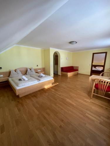 a large living room with a bed and a couch at Landhaus Metzgerstubn in Sankt Martin
