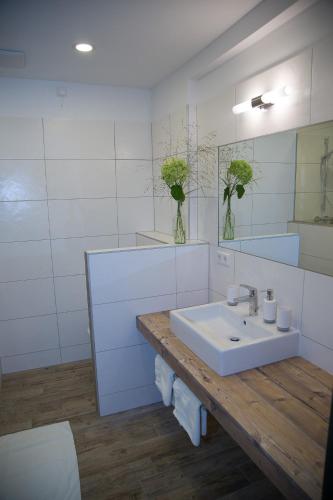 a white bathroom with a sink and a mirror at Krumbacherhof in Krumbach Markt