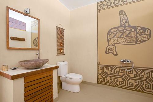 a bathroom with a toilet and a sink at Whales and Waves in Lemonga