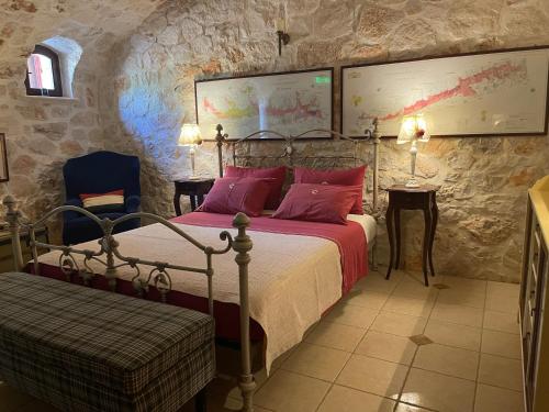 a bedroom with a bed with red pillows at Boutique apart-hotel Galini, member of the best small hotels in Greece, Adults only in Volímai