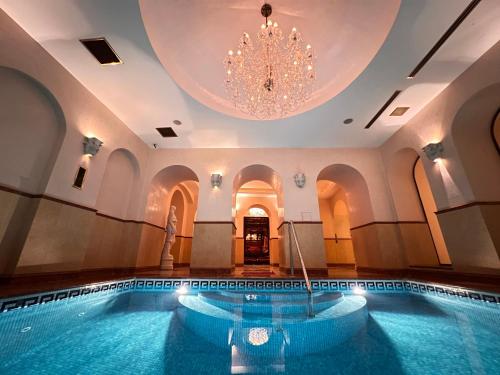 a swimming pool in a building with a chandelier at Alchymist Grand Hotel and Spa - Preferred Hotels & Resorts in Prague