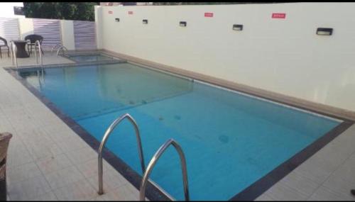 a large swimming pool with blue water in a building at Fern Residency Jodhpur in Jodhpur