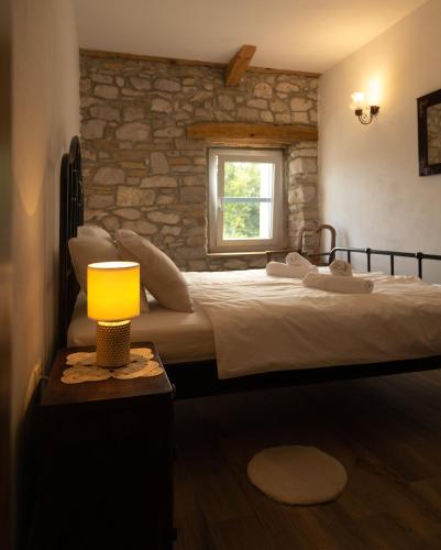 a bedroom with a large bed and a window at Villa Klara in Buzet
