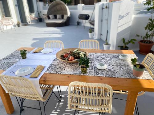 a wooden table with a bowl of food on it at 1812 Caves 'n Mansion in Karterados