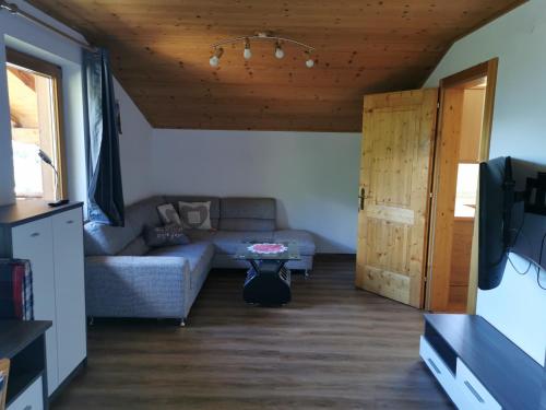 a living room with a couch and a table at Ferienwohnung Mühlburger in Virgen
