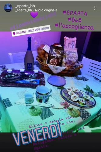 a table with a bottle of wine and some food at SPARTA in Ercolano