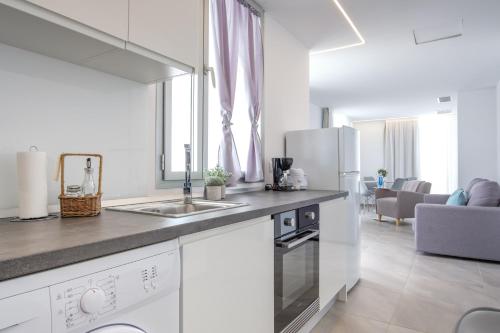a kitchen with a sink and a counter top at Sea Breeze Apartments in Cala Millor