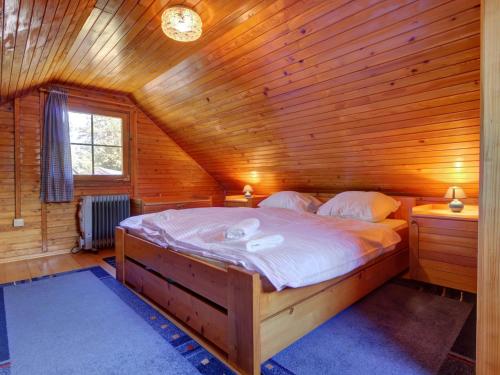 a bedroom with a bed in a wooden cabin at Chalet 68 Terme Čatež with Swimming tickets in Brežice