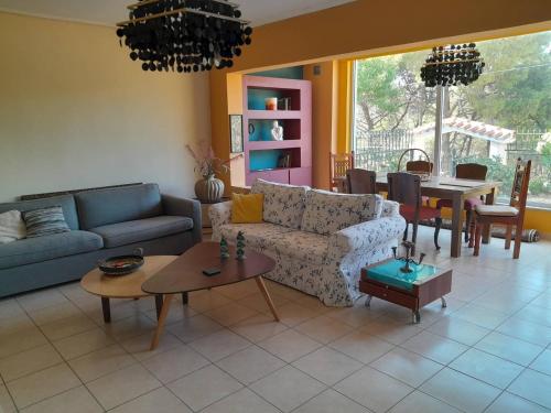 a living room with a couch and a table at PARADISE in Dhaskalión