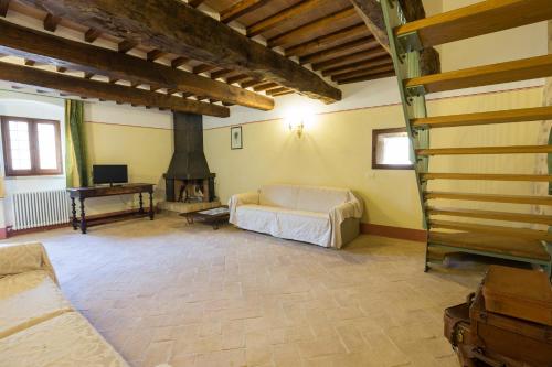 a living room with a couch and a fireplace at Borgo Colognola - Dimora Storica in Cenerente