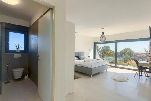 a bedroom with a bed and a living room at Villa Valdo by Istra Vacation in Marčana