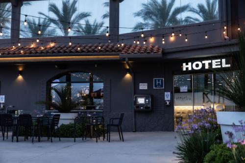 a hotel with chairs and lights on a building at Hotelet elRetiro in Cambrils