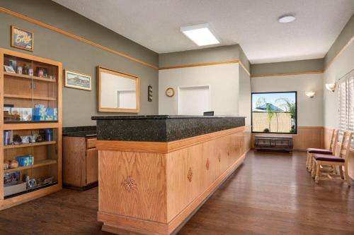 a bar in a room with a counter at Super 8 by Wyndham Lindsay Olive Tree in Lindsay