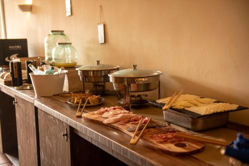 a kitchen counter filled with lots of different types of food at Hotel Convent de Begur in Begur