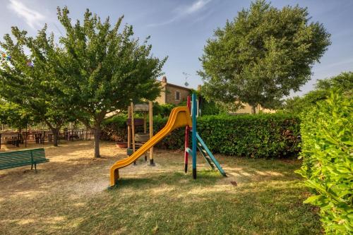 a playground with a slide in a park at La Casa Di Campagna in Magione
