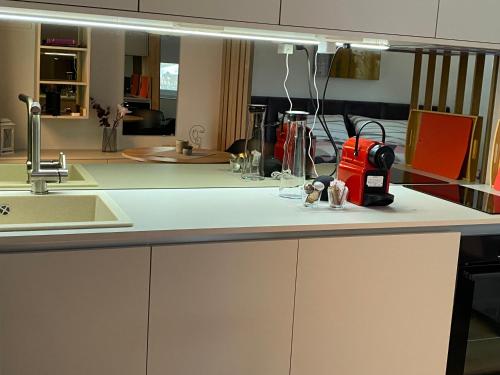 a kitchen counter with a sink and a appliance on it at Artatore24 - Modern and stylish Apartments in Mali Lošinj